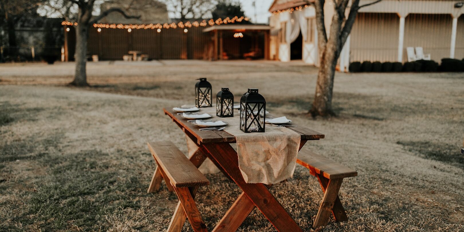 rectangular brown wooden picnic table on the field